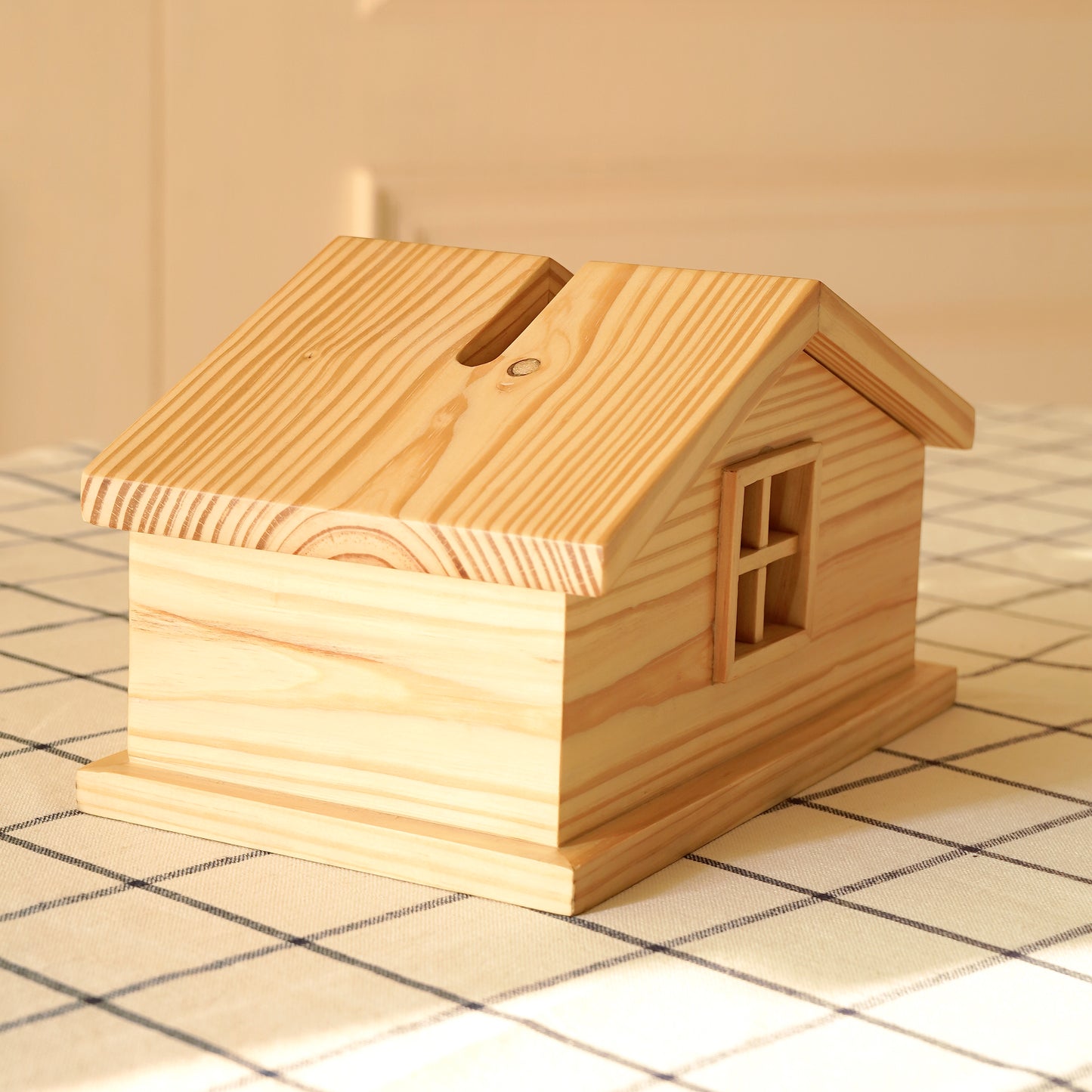 Cabin style tissue holder made of natural wood with a pitched roof design by A Good Life