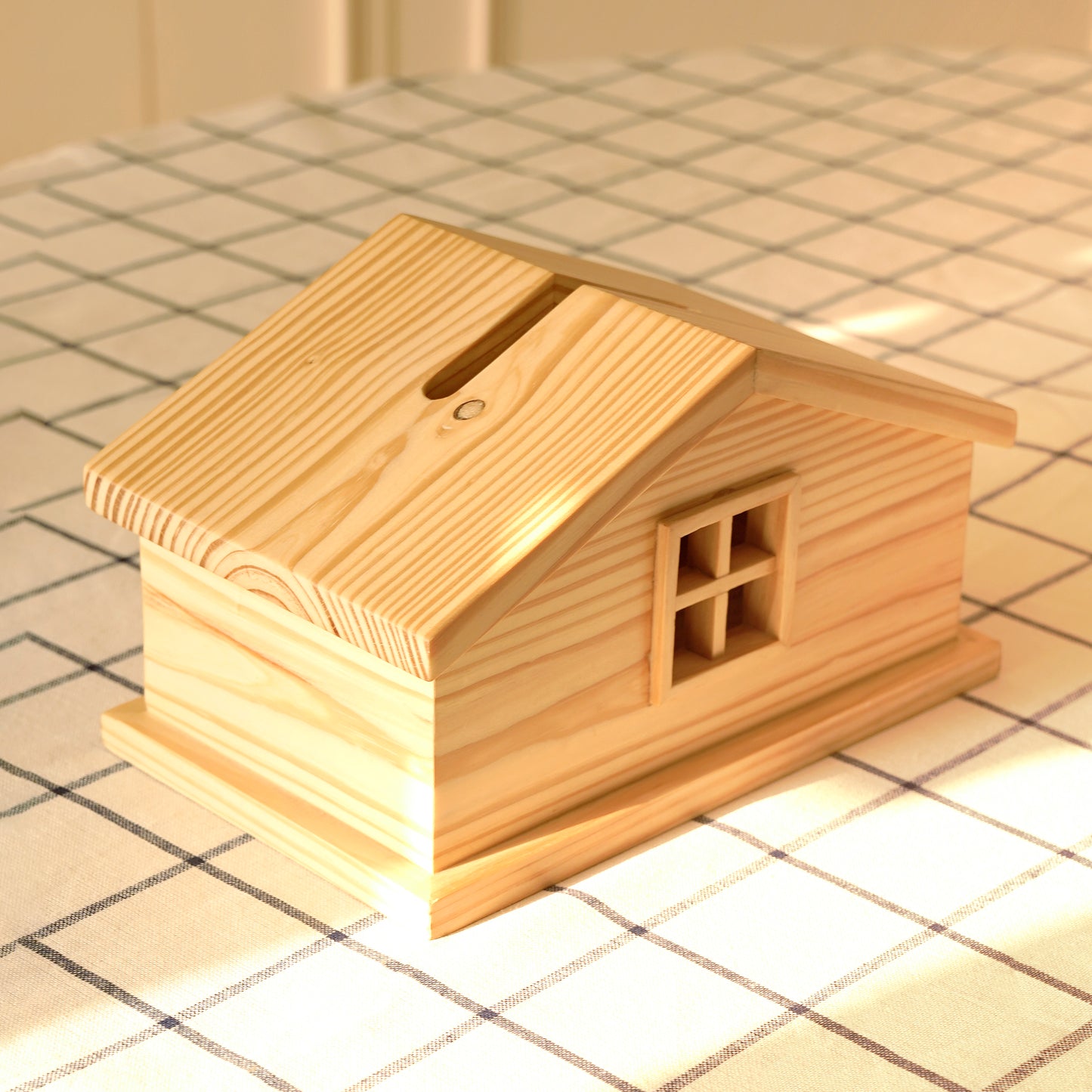 Wooden cabin style tissue holder shaped like a small house with a slanted roof and window details