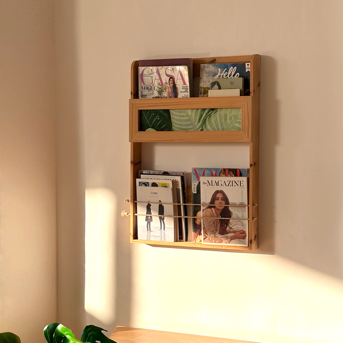 A Good Life Quote Bookshelf mounted on wall holding magazines in a minimalist magazine rack design
