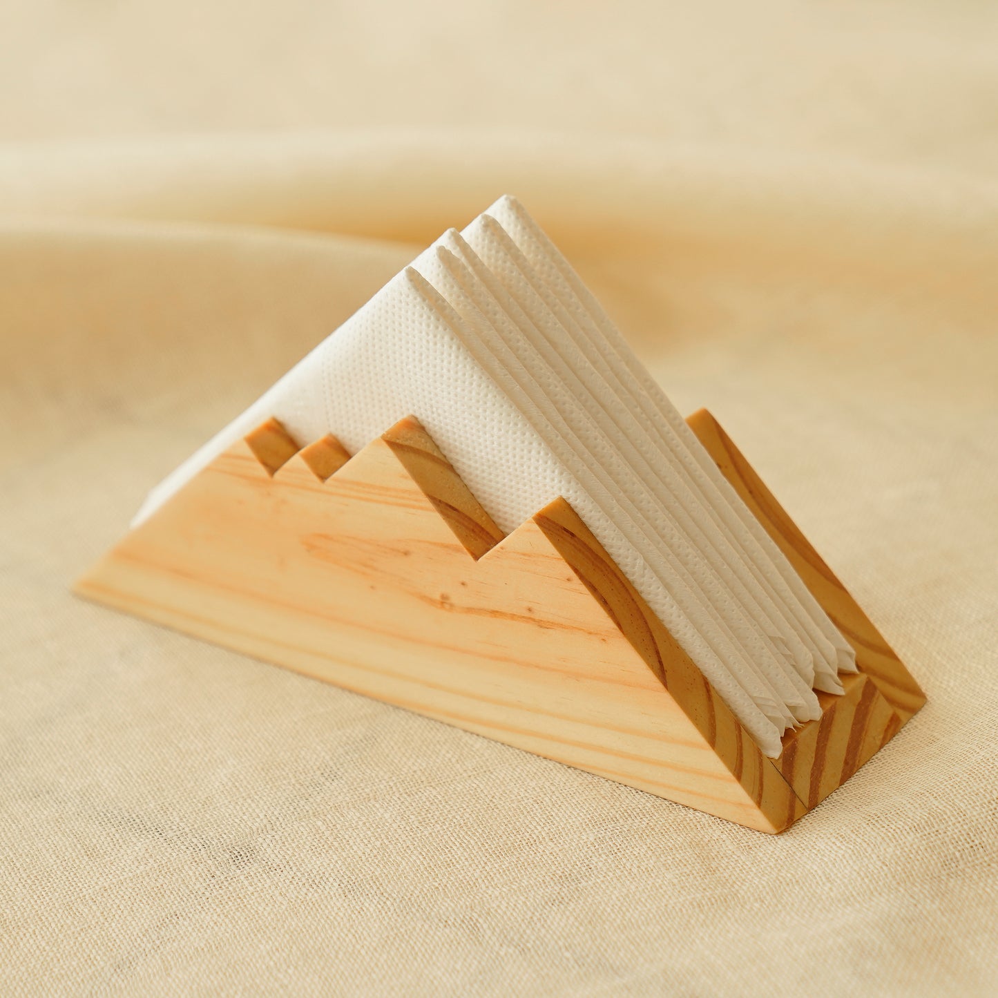 Everest napkin holder solid wood with a mountain peak design holding white napkins