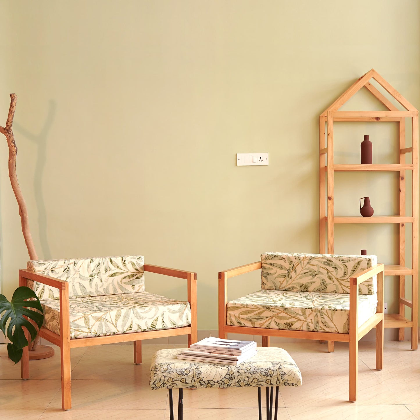 A Good Life minimalist pinewood lounge chair set with floral cushions in a modern living room