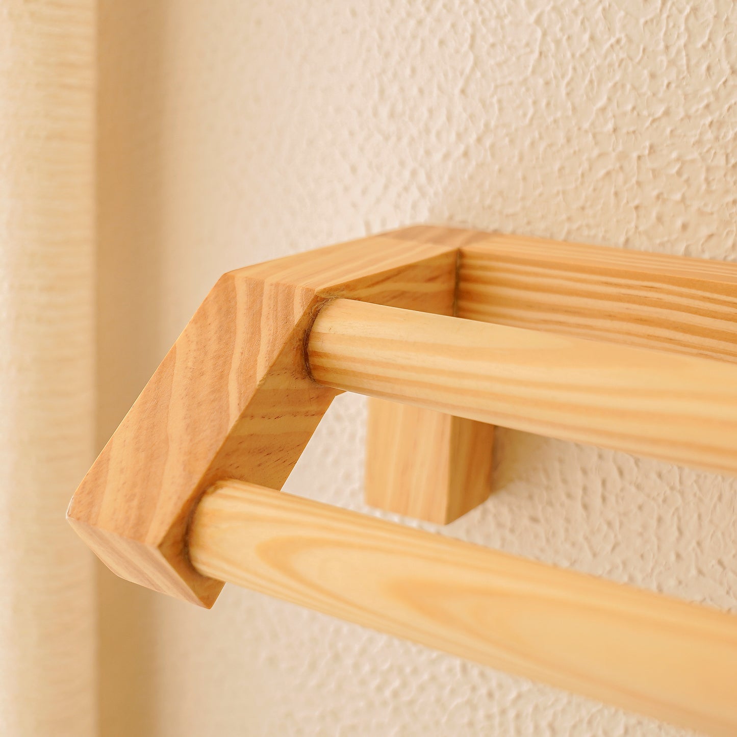Minimalist wooden hand towel rail by A Good Life mounted on textured wall with light natural finish