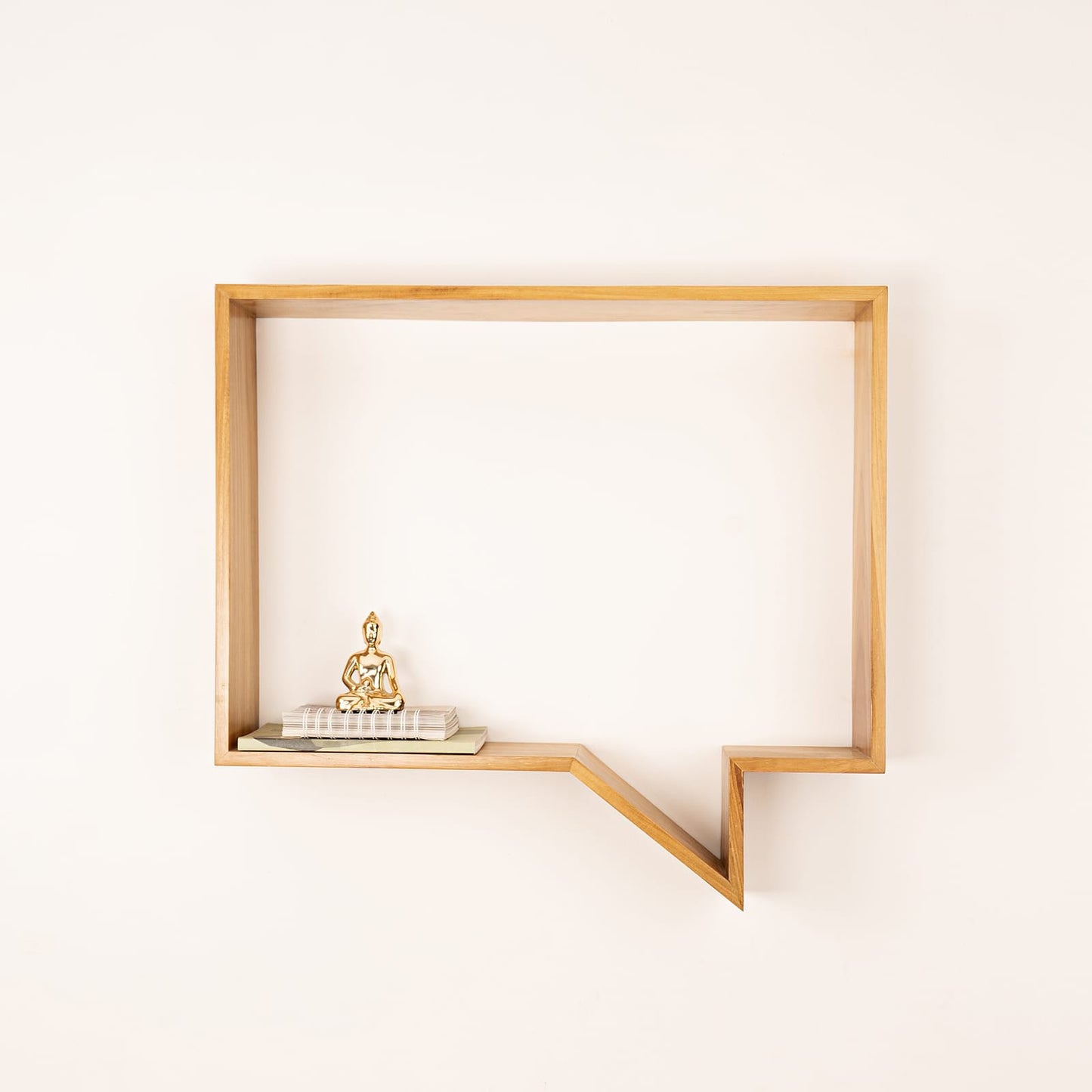 Minimalist wooden Wabi-Sabi quote display shelf mounted on wall with decorative Buddha statue and books