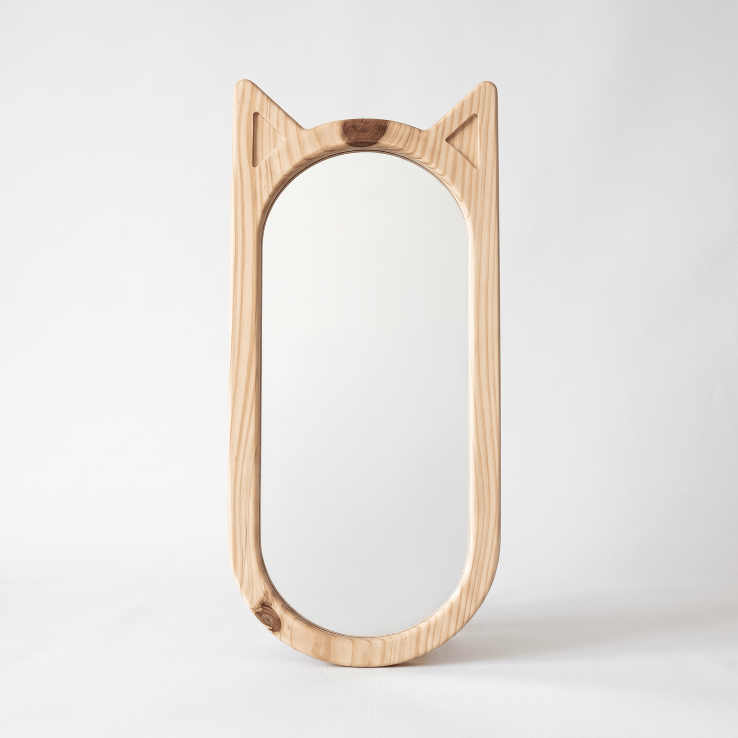 Hana wooden cat-ear mirror in natural pinewood styled in a minimalist Japandi living room — A Good Life