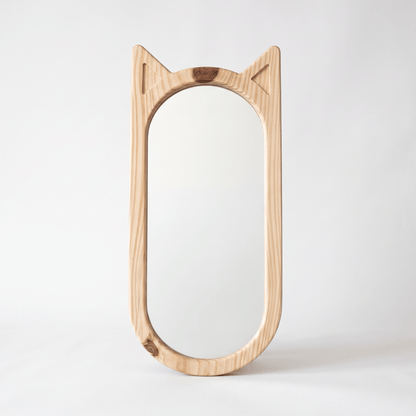 Hana wooden cat-ear mirror in natural pinewood styled in a minimalist Japandi living room — A Good Life
