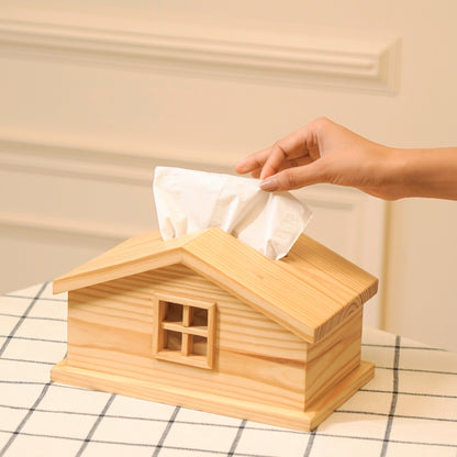 Cabin style tissue holder made of natural wood with a window design on a checkered table