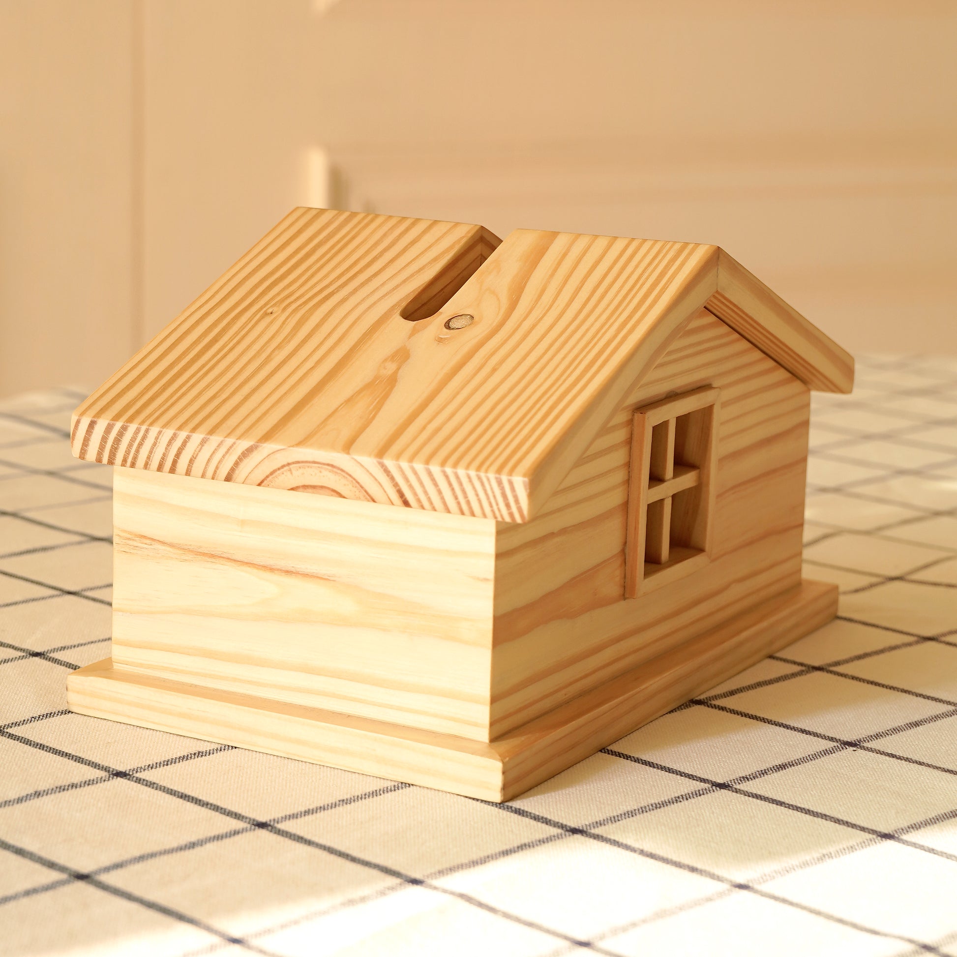 Cabin style tissue holder made of natural wood with a pitched roof design by A Good Life