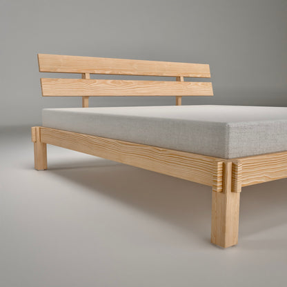 Minimalist pinewood bed frame side view showing solid construction and natural grain for Nordic bedroom