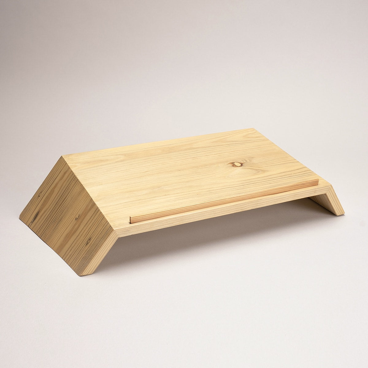 Natural pinewood laptop stand in modern home office - sustainable ergonomic desk riser for better posture and productivity