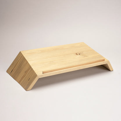 Natural pinewood laptop stand in modern home office - sustainable ergonomic desk riser for better posture and productivity