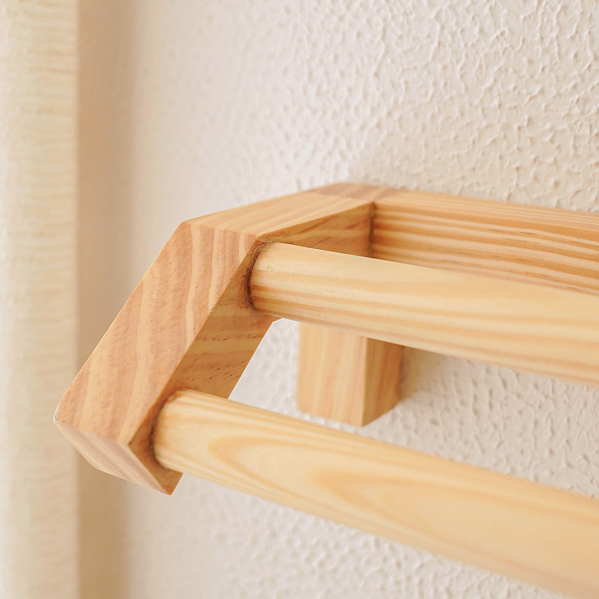 Nordic minimalist bathroom hand towel rail in natural pinewood with wall-mounted design for small space organization