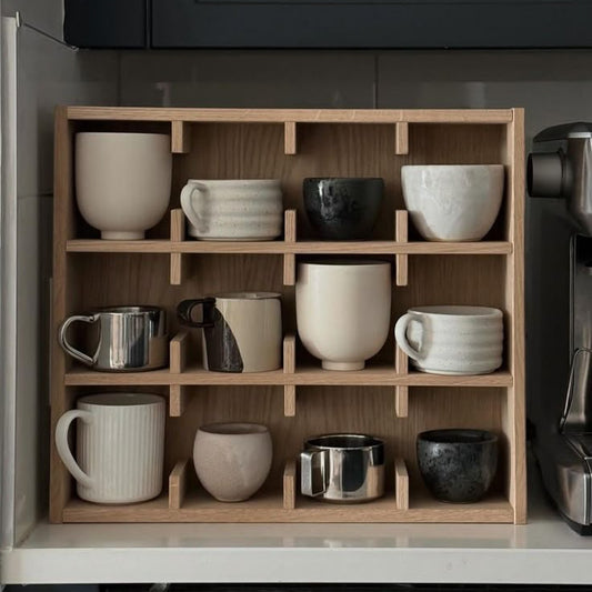 A Good Life minimalist wooden mug rack holding various ceramic and metal mugs in a kitchen setting