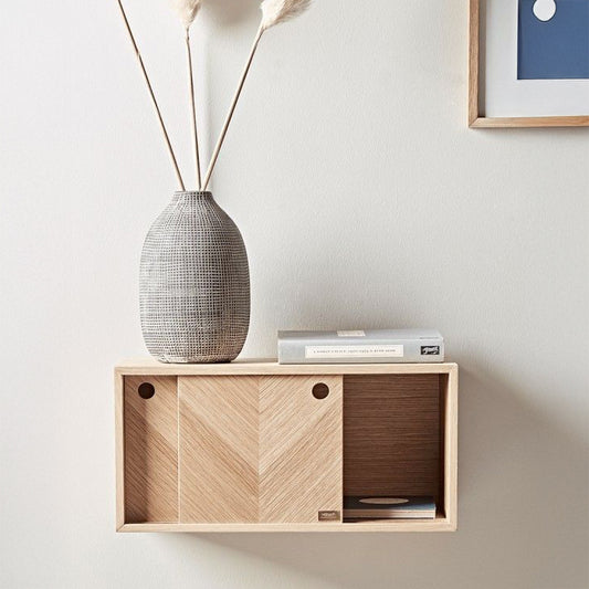 A Good Life wabi-sabi floating shelf in natural wood with sliding doors and decorative vase on top