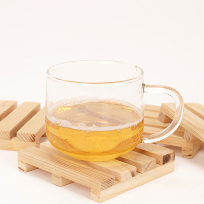 Glass cup of tea on wooden pallet coasters by A Good Life with natural wood finish