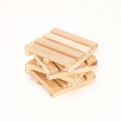 A stack of wooden pallet coasters by A Good Life made from light natural wood with slatted design